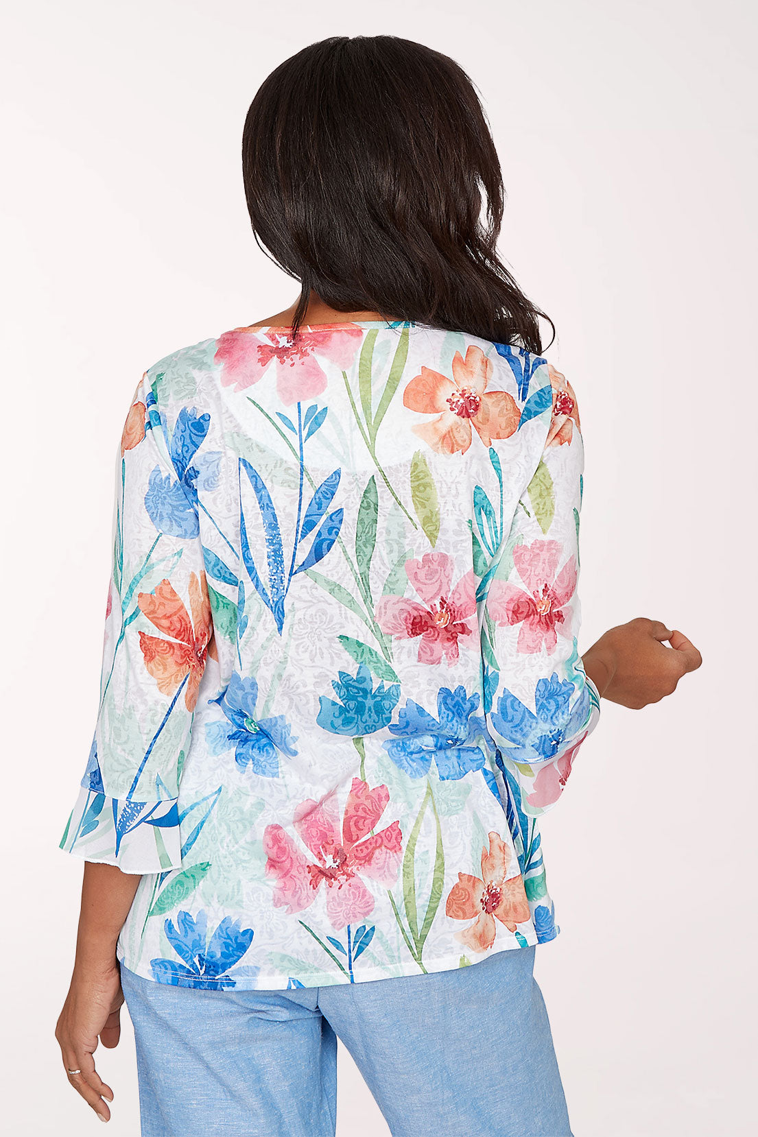Woman wearing a floral blouse with a white background
