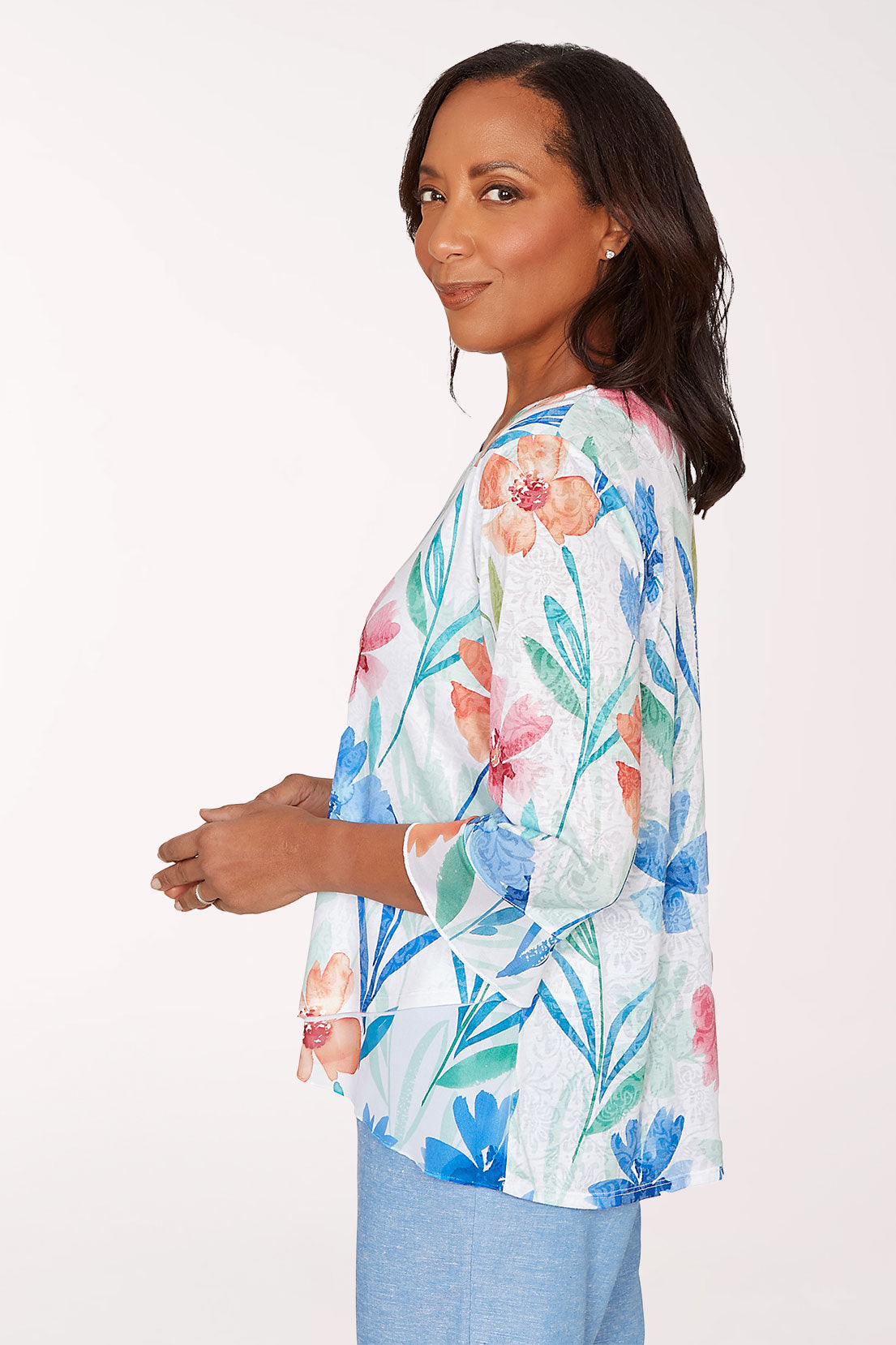 Woman wearing a floral blouse with a white background