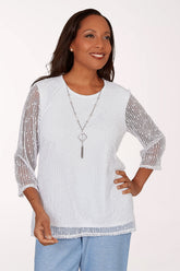 Woman wearing a white top with sheer sleeves on a white background