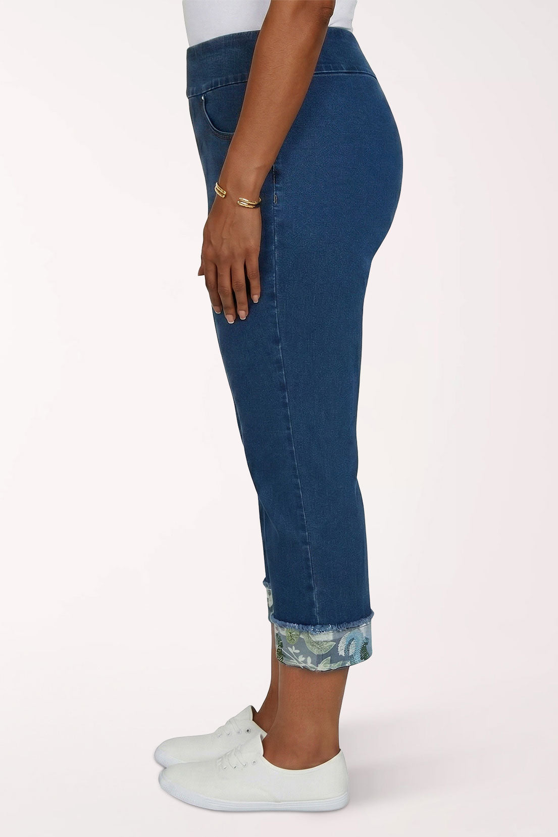 Woman wearing a denim cropped pant with floral hem 