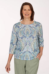 Woman wearing a blue paisley 3/4 sleeve top