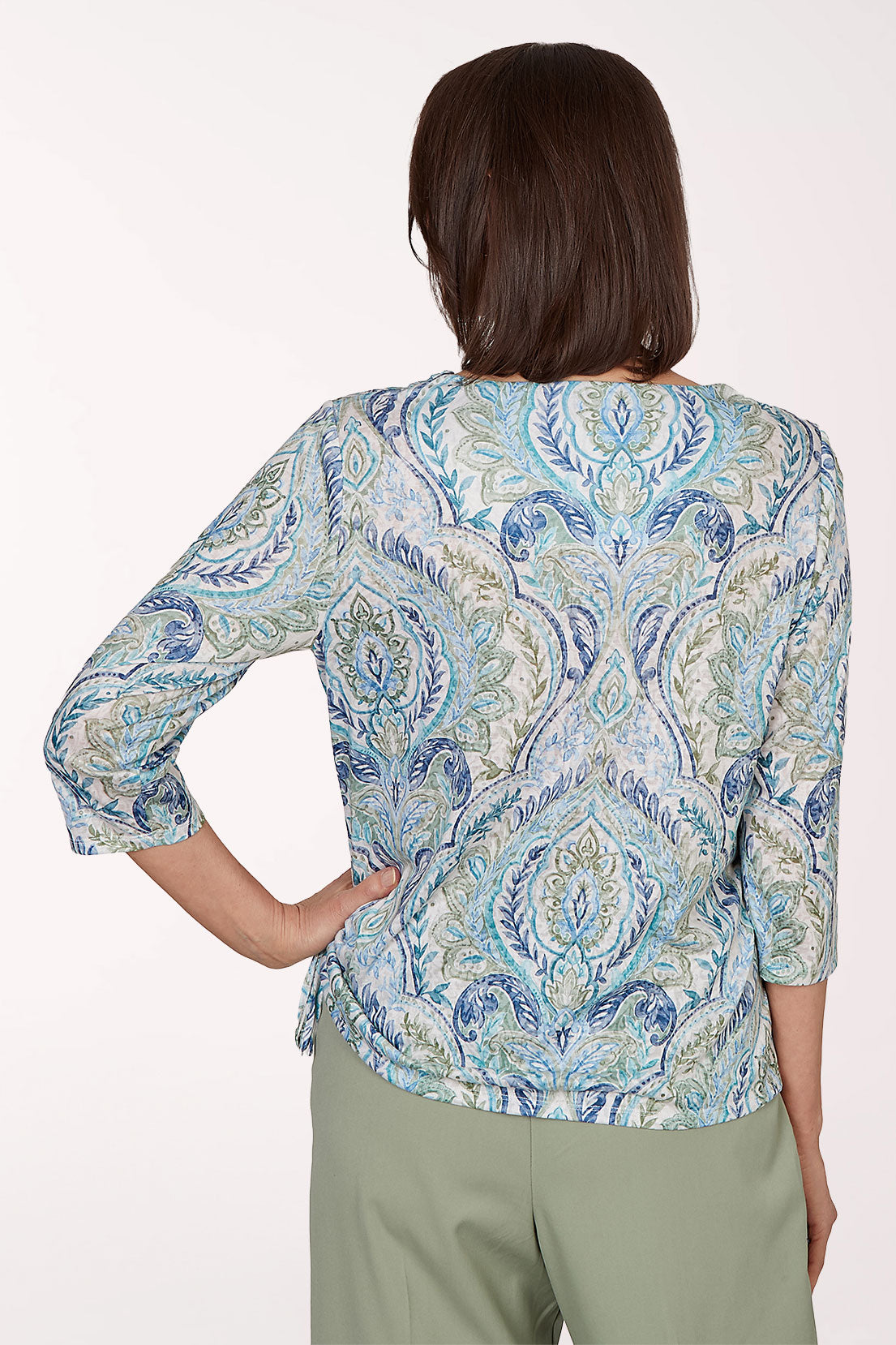 Woman wearing a blue paisley 3/4 sleeve top