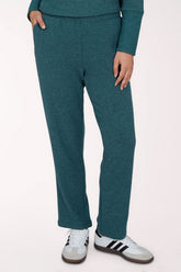 A person wearing heathered teal lounge pants with a matching long-sleeve top and white sneakers, shown from the waist down against a plain light background.
