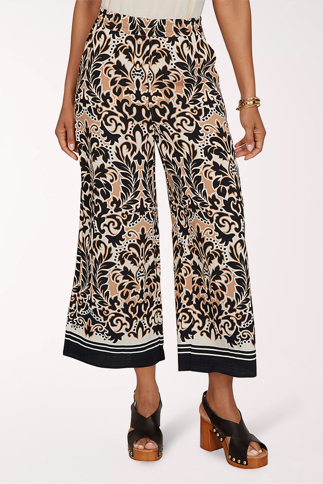 Patterned wide-leg pants worn by a person on a white background