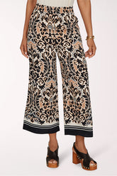 Patterned wide-leg pants worn by a person on a white background