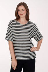 Woman wearing a black and white striped shirt on a white background