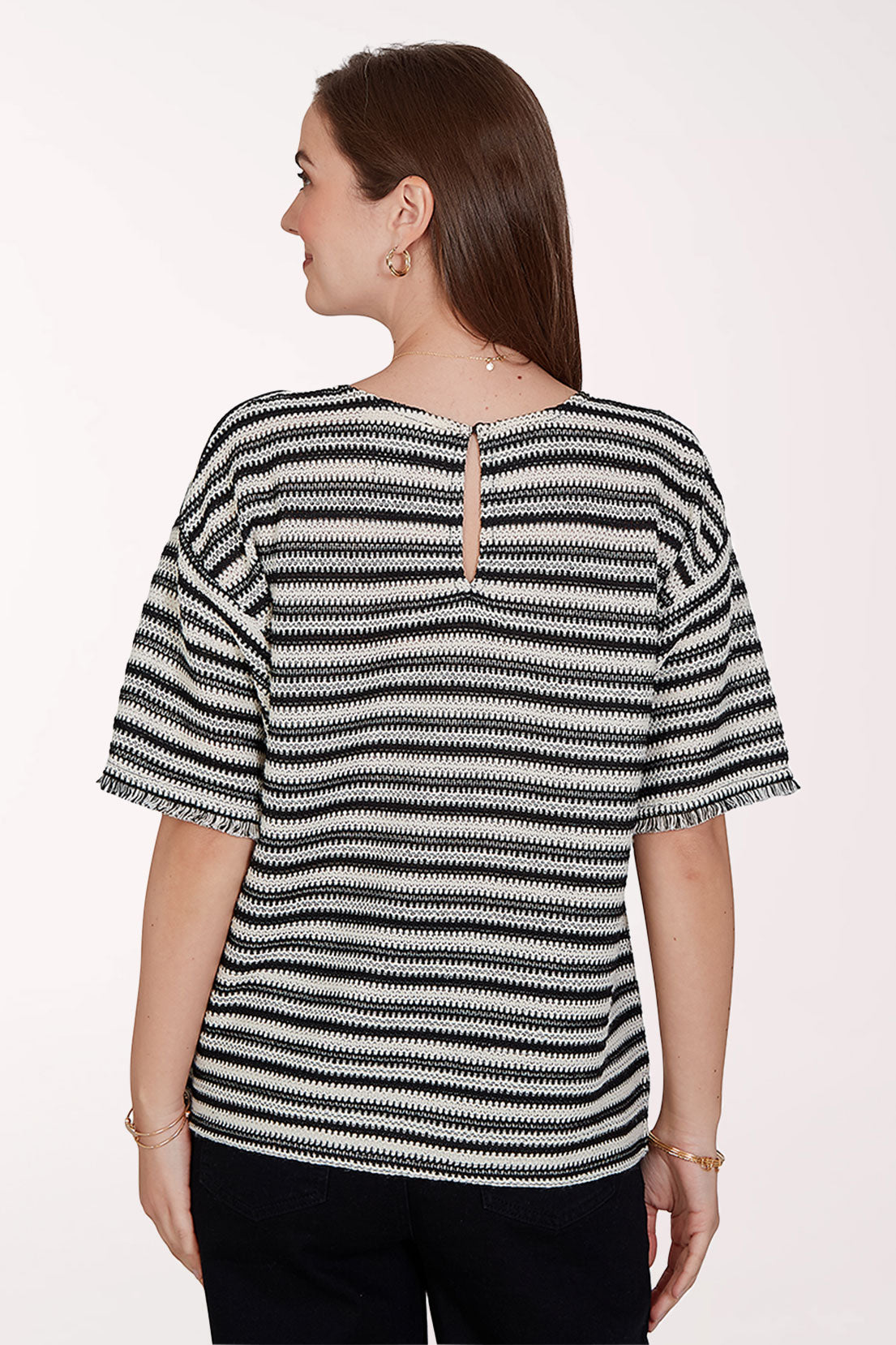 Woman wearing a black and white striped shirt on a white background