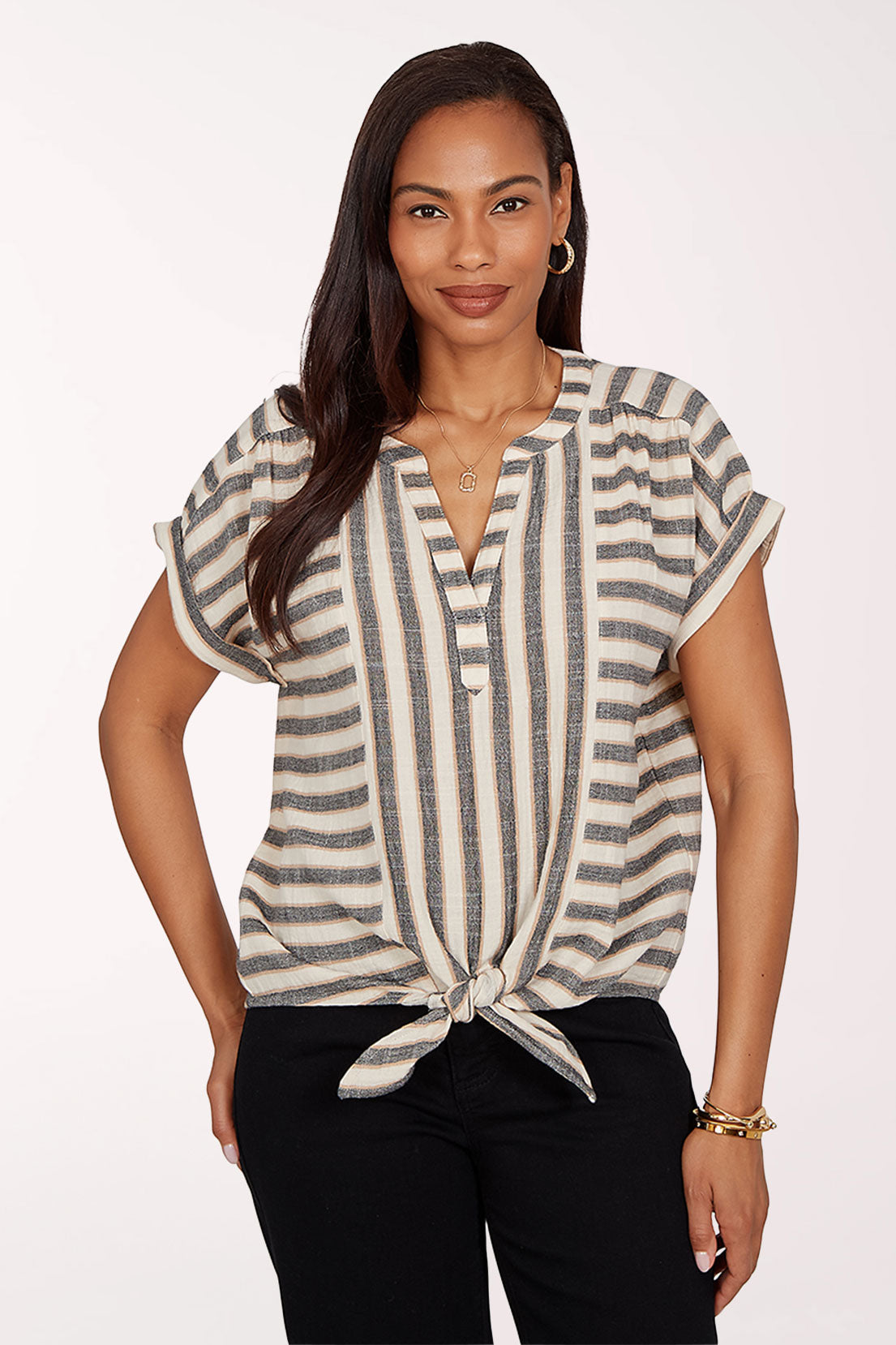 Woman wearing a striped top with a knot detail on a white background