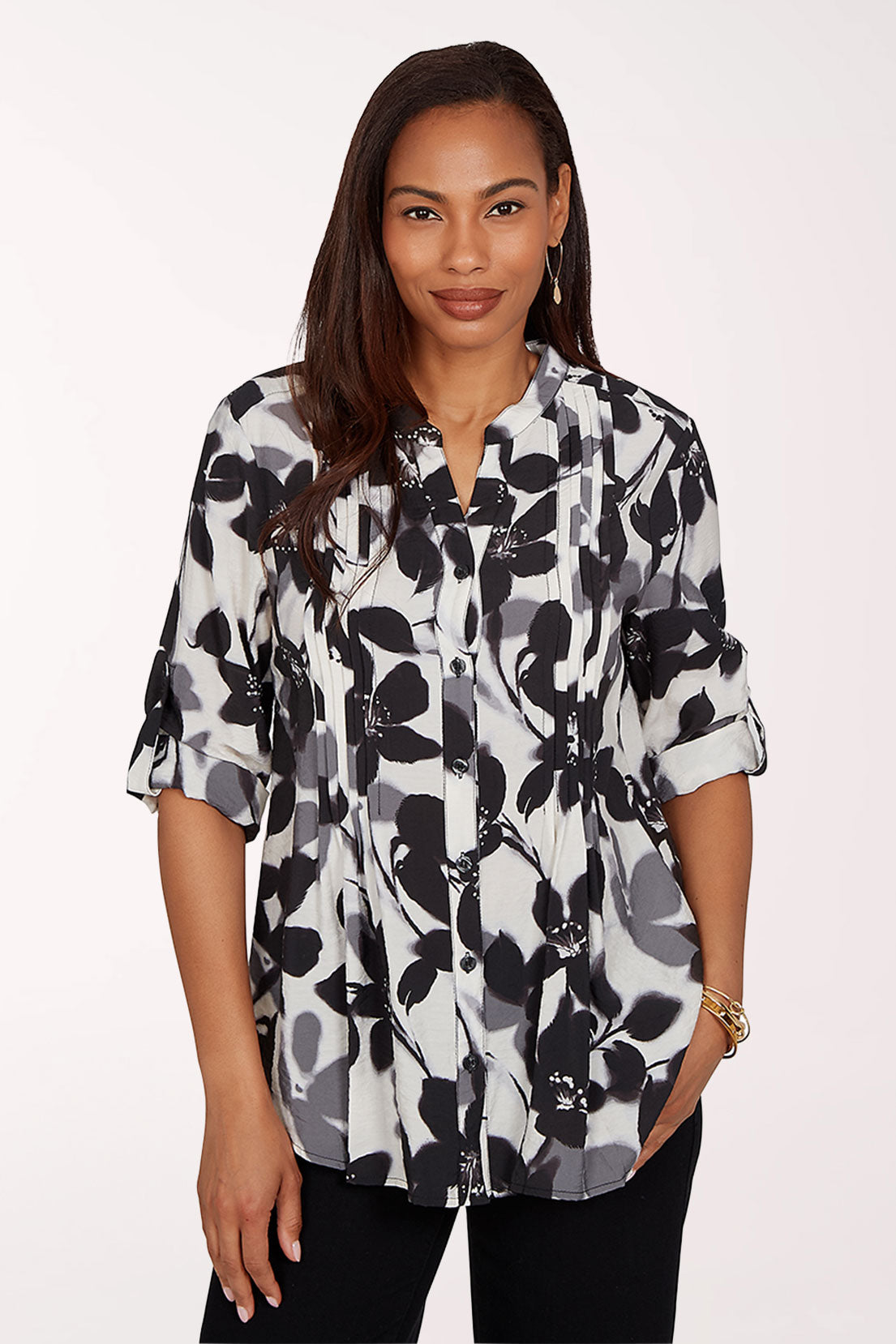 Woman wearing a black and white floral blouse on a white background