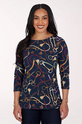 Woman wearing a 3/4 sleeve navy top with an equestrian pattern