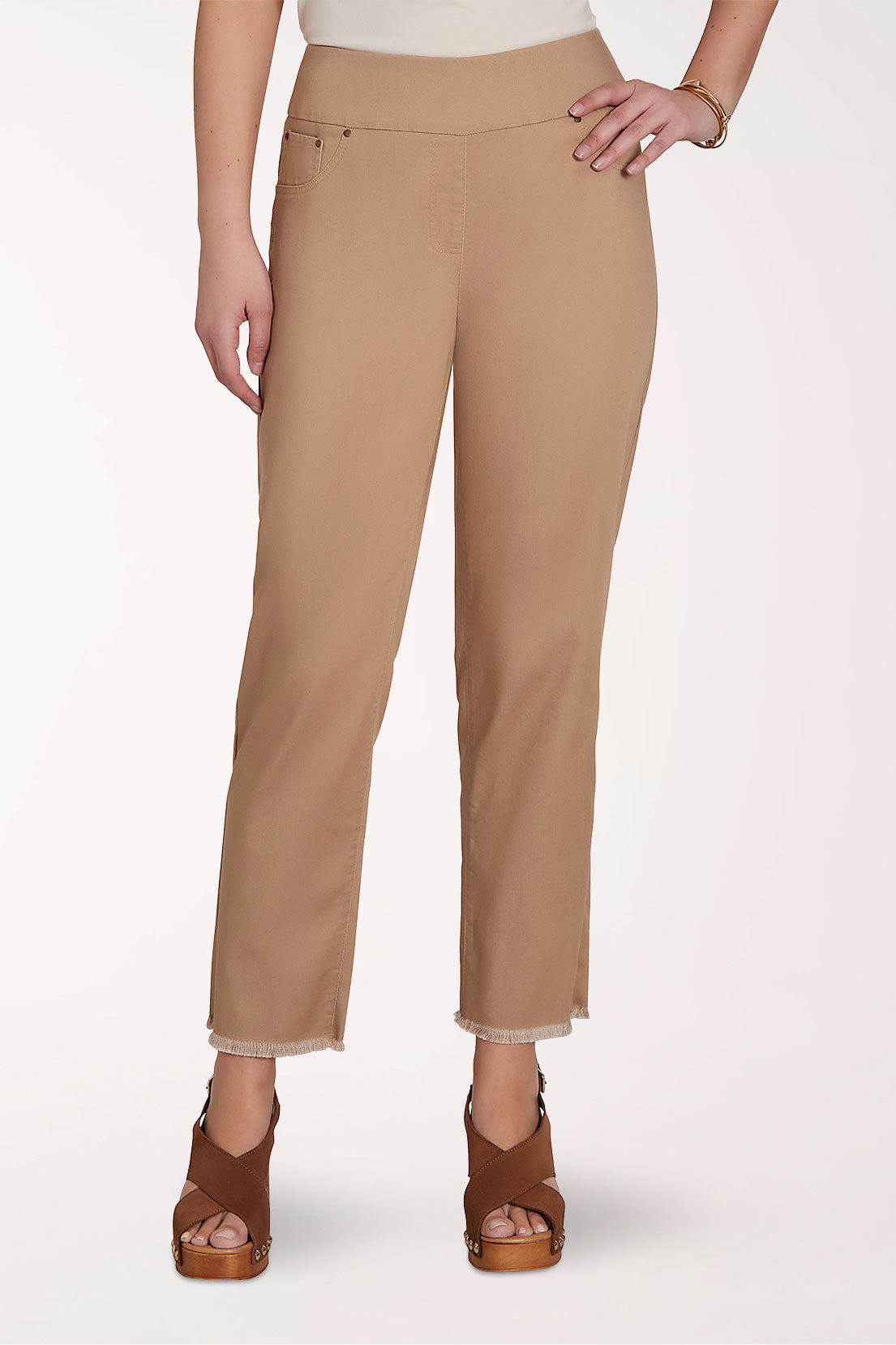 Beige pants worn by a person on a white background