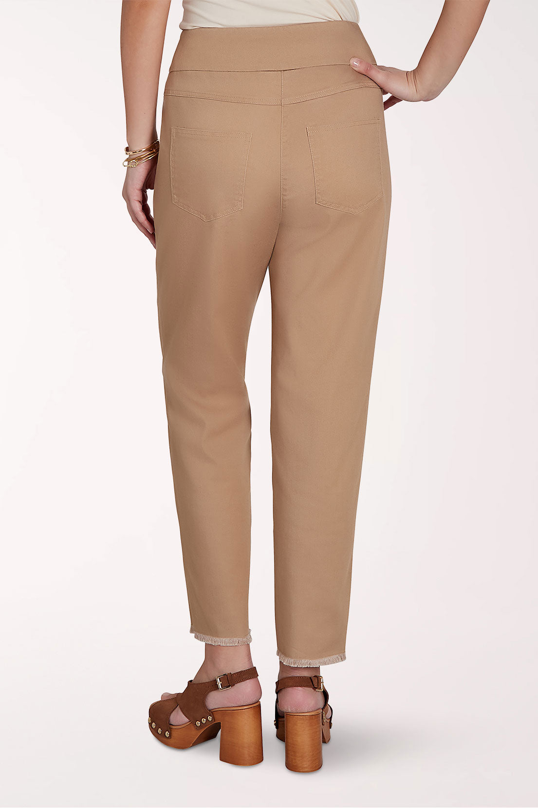 Beige pants worn by a person on a white background