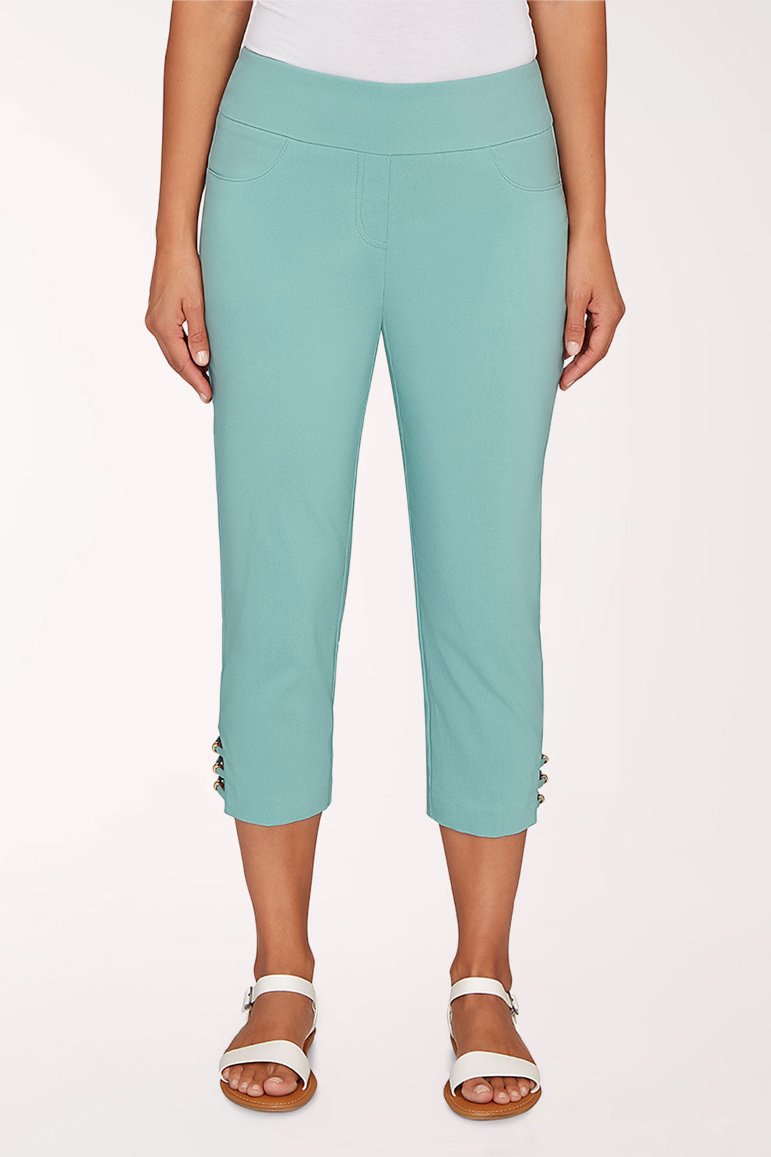 Person wearing a turquoise cropped pant on a white background