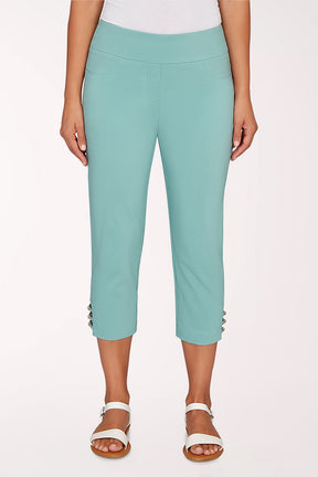 Person wearing a turquoise cropped pant on a white background