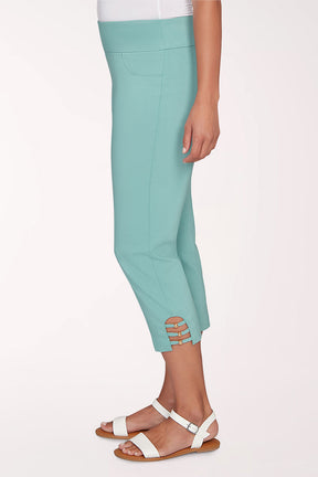 Person wearing a turquoise cropped pant on a white background