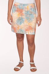Person wearing a colorful patterned skirt on a white background