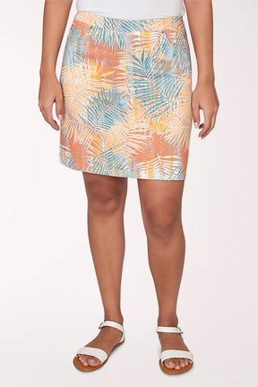 Woman wearing a multicolored tropical print skort.