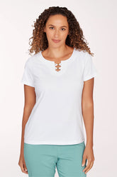 Woman wearing a white shirt with a front lace-up design on a light pink background