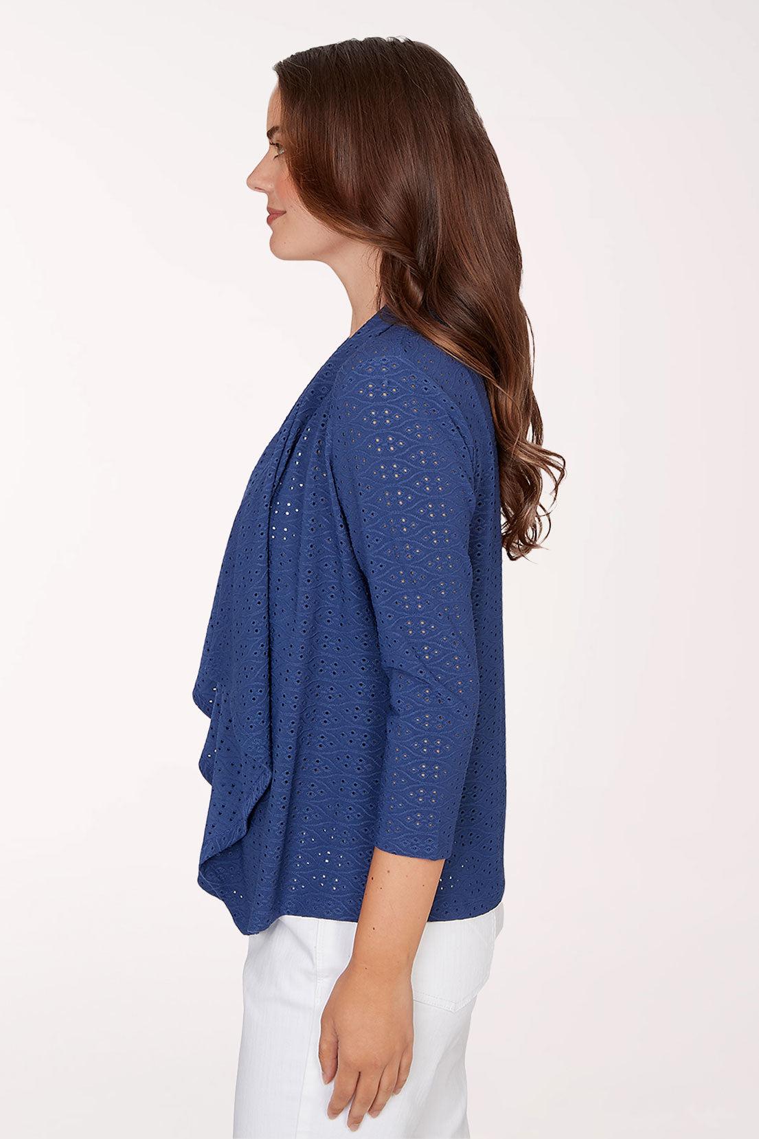 Woman wearing a blue cardigan with a white background