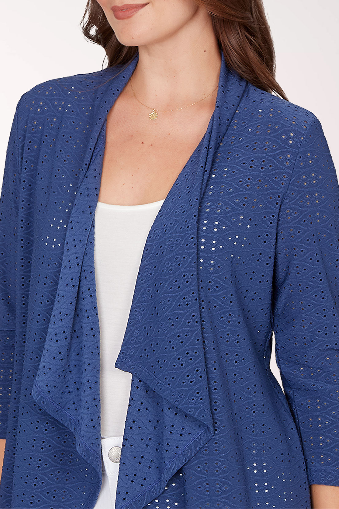 Woman wearing a blue cardigan with a white background