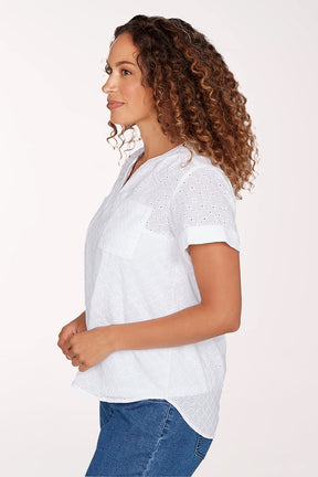 Woman wearing a white blouse with short sleeves and blue jeans on a white background