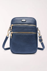 Front view of the 22 Tote Three-Pocket Crossbody Bag in navy pebbled faux leather: a small upright bag with two horizontal zippered pockets across the front, gold zippers and hardware, and an adjustable crossbody strap.