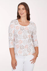 Woman wearing a floral patterned top on a white background