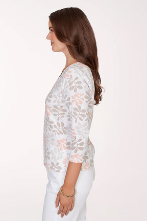 Woman wearing a floral patterned top on a white background
