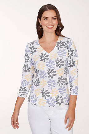 Woman wearing a floral-patterned shirt with a plain background