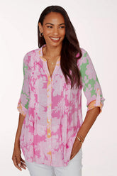 Woman wearing a pink floral blouse on a white background