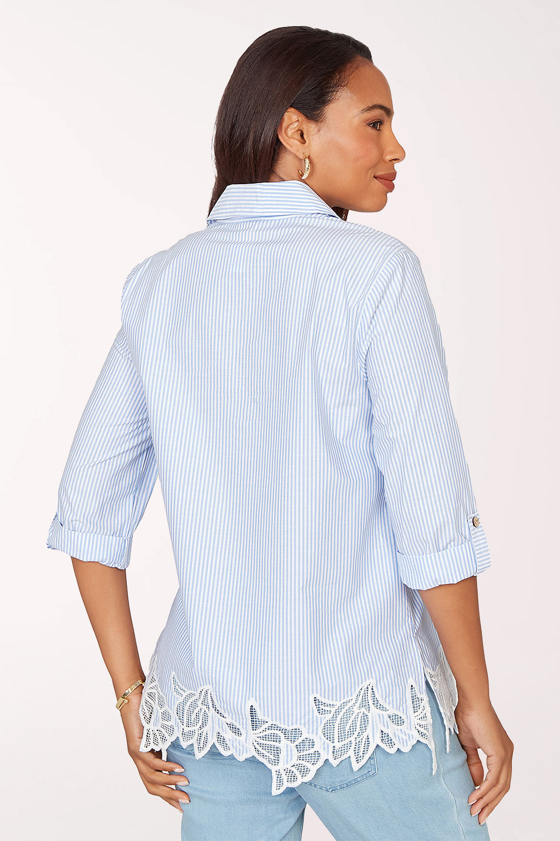 Woman wearing a 3/4 sleeve blue top.