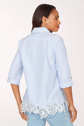 Woman wearing a 3/4 sleeve blue top.