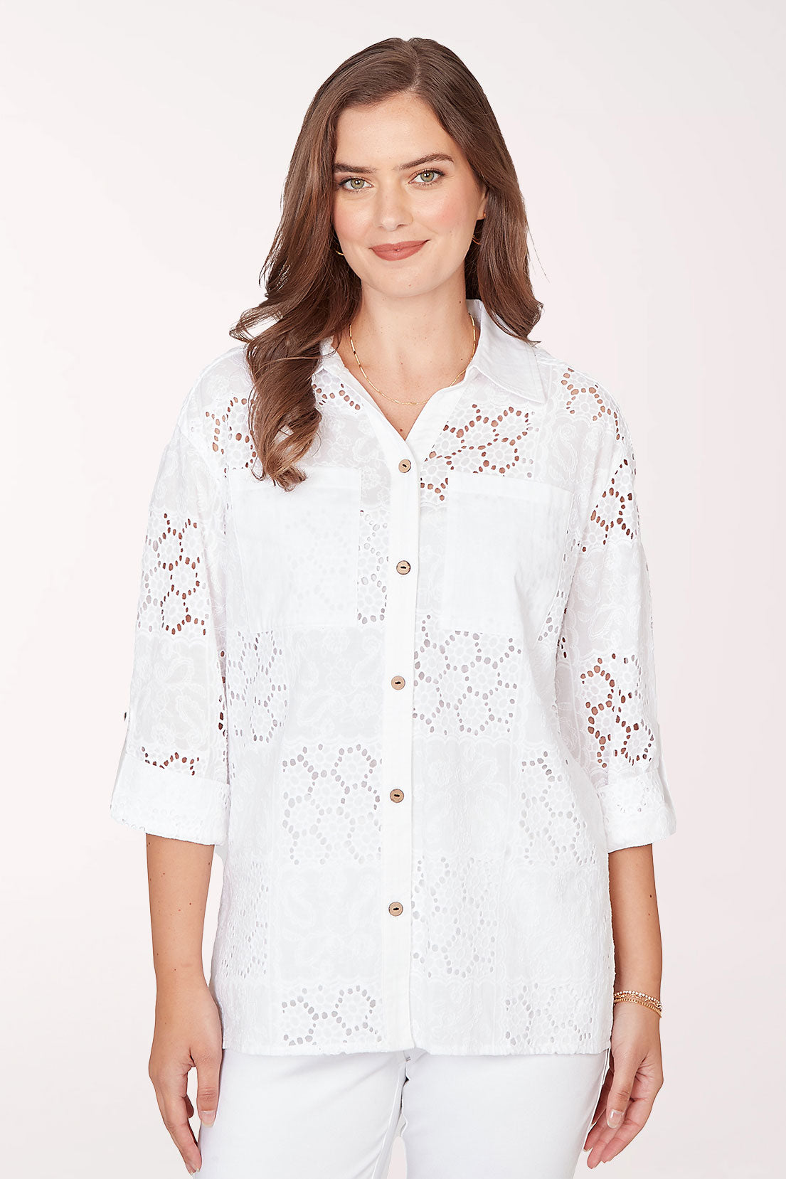 Woman wearing a 3/4 sleeve button-up white top.
