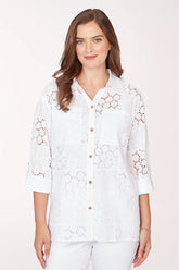 Woman wearing a 3/4 sleeve button-up white top.