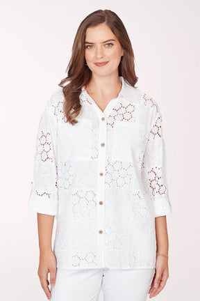 Woman wearing a 3/4 sleeve button-up white top.
