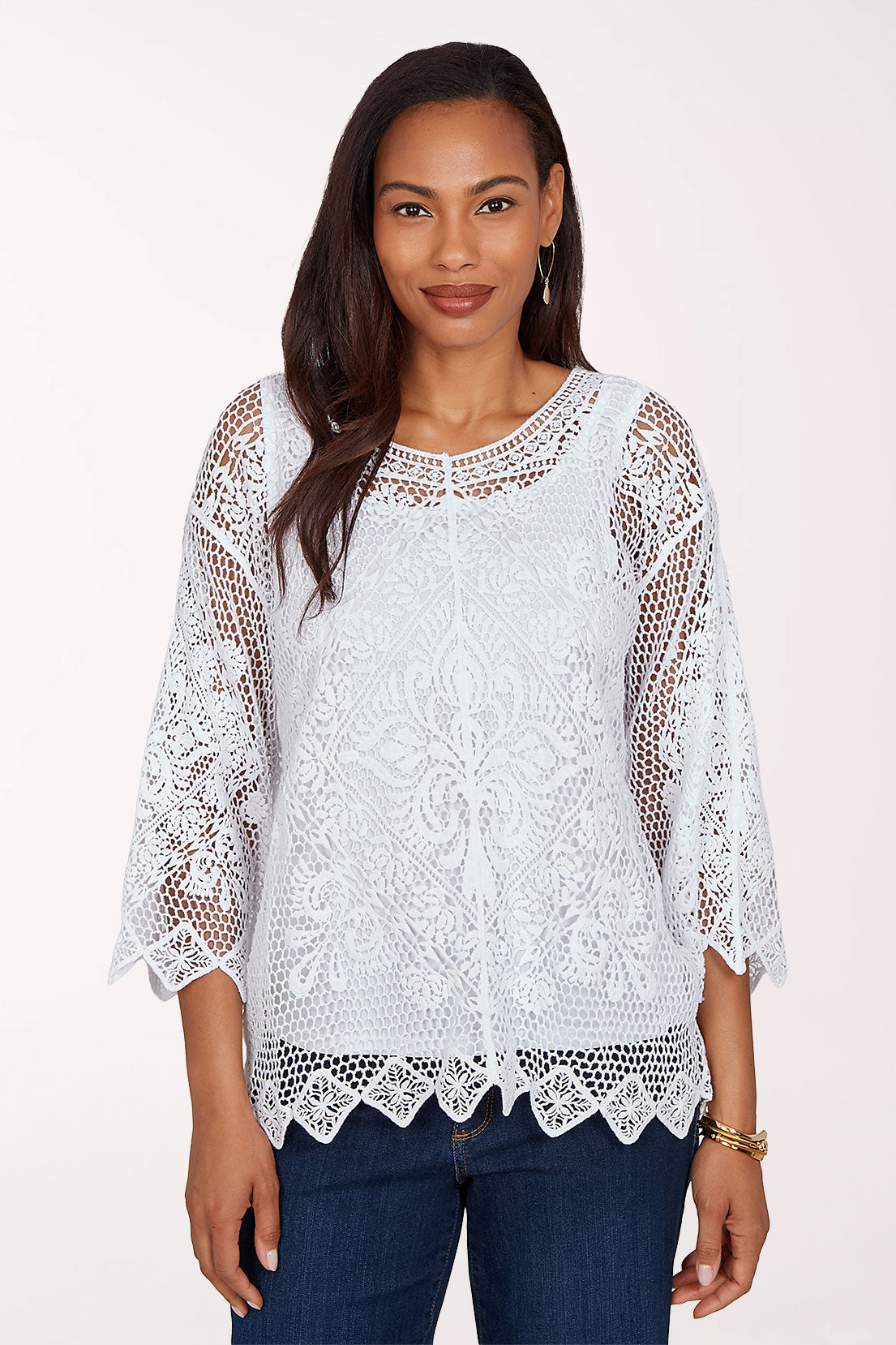 Woman wearing a white crochet top.