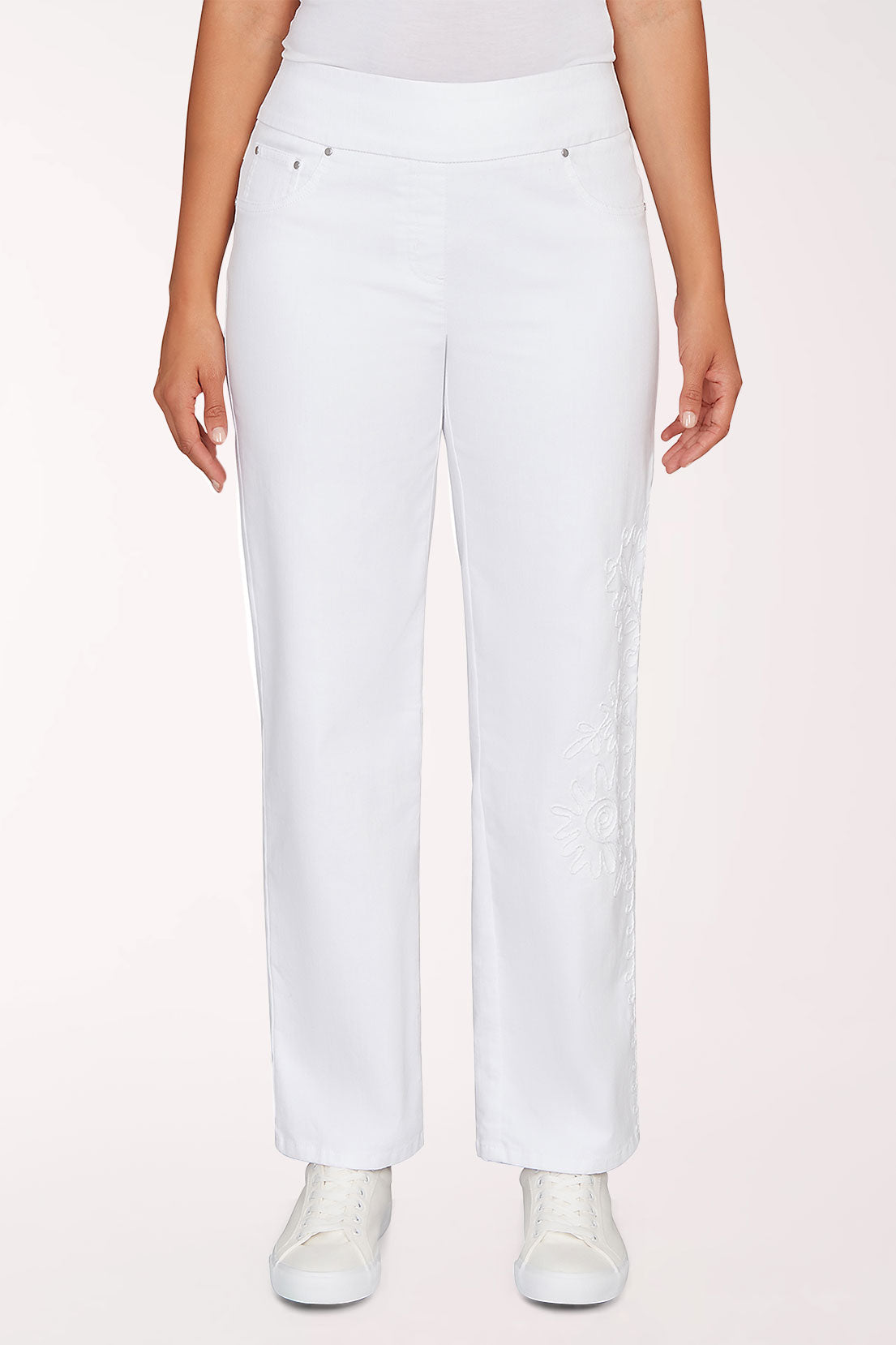 Person wearing white pants on a light pink background