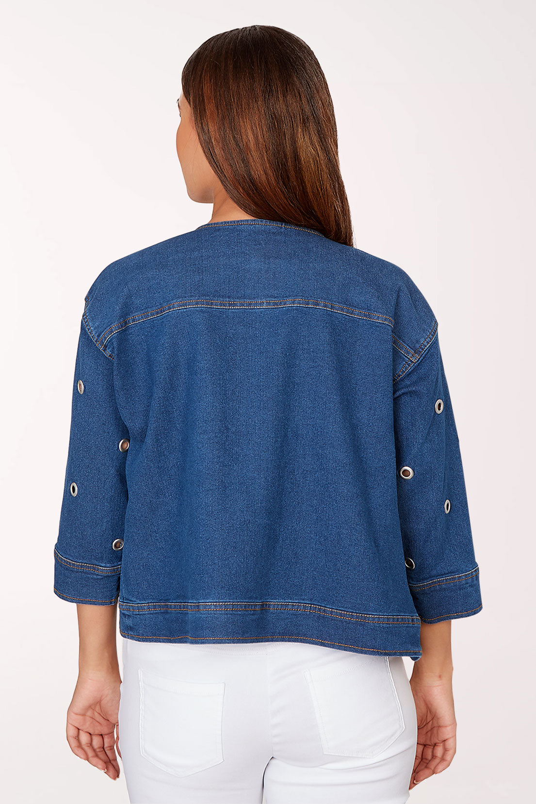 Woman wearing a blue denim jacket on a white background