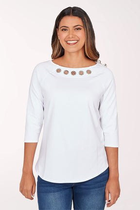 Woman wearing a light blue top with decorative buttons on a white background