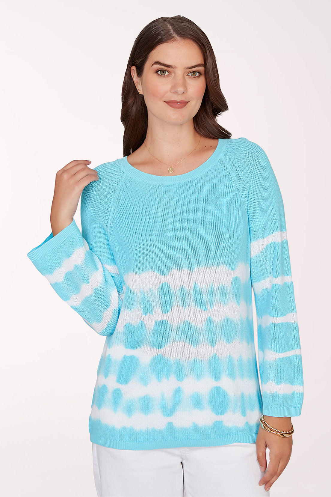 Woman wearing a blue and white tie-dye sweater on a white background