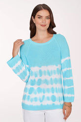 Woman wearing a blue and white tie-dye sweater on a white background