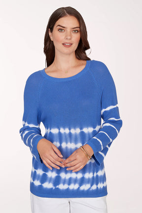 Woman wearing a blue and white tie-dye sweater on a white background