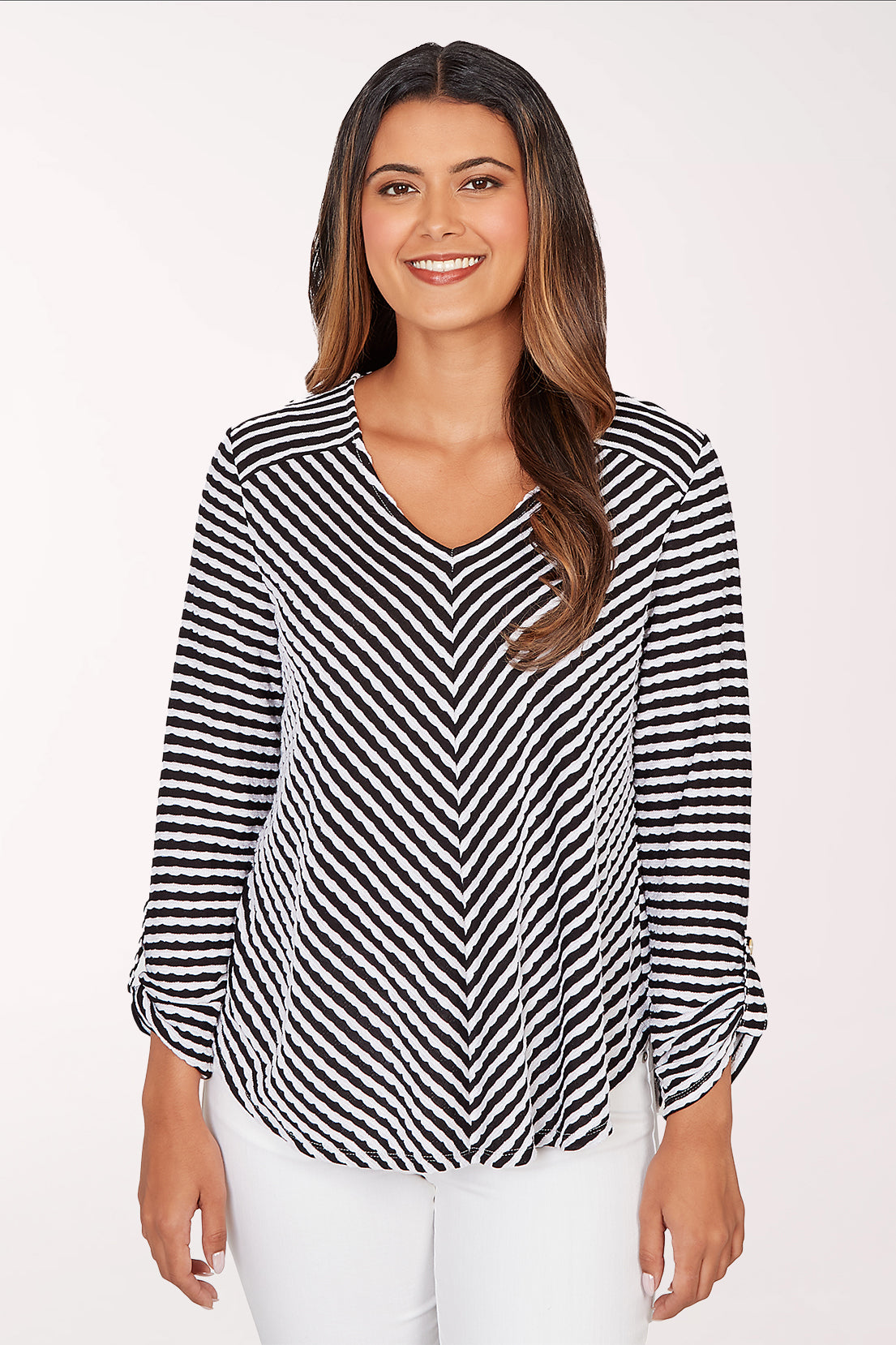 Woman wearing a black and white striped blouse on a white background