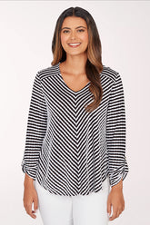 Woman wearing a black and white striped blouse on a white background