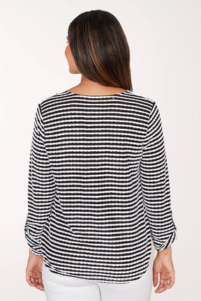 Woman wearing a black and white striped blouse on a white background