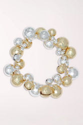 Periwinkle Gold And Silver Jingle Bells Bracelet, a stretch bracelet covered in shiny gold and silver jingle bells with small crystal accents.
