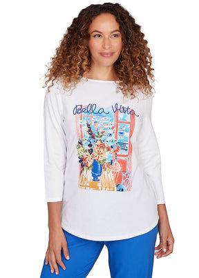 Woman wearing a white t-shirt with colorful graphic design and 'Bella Vista' text.