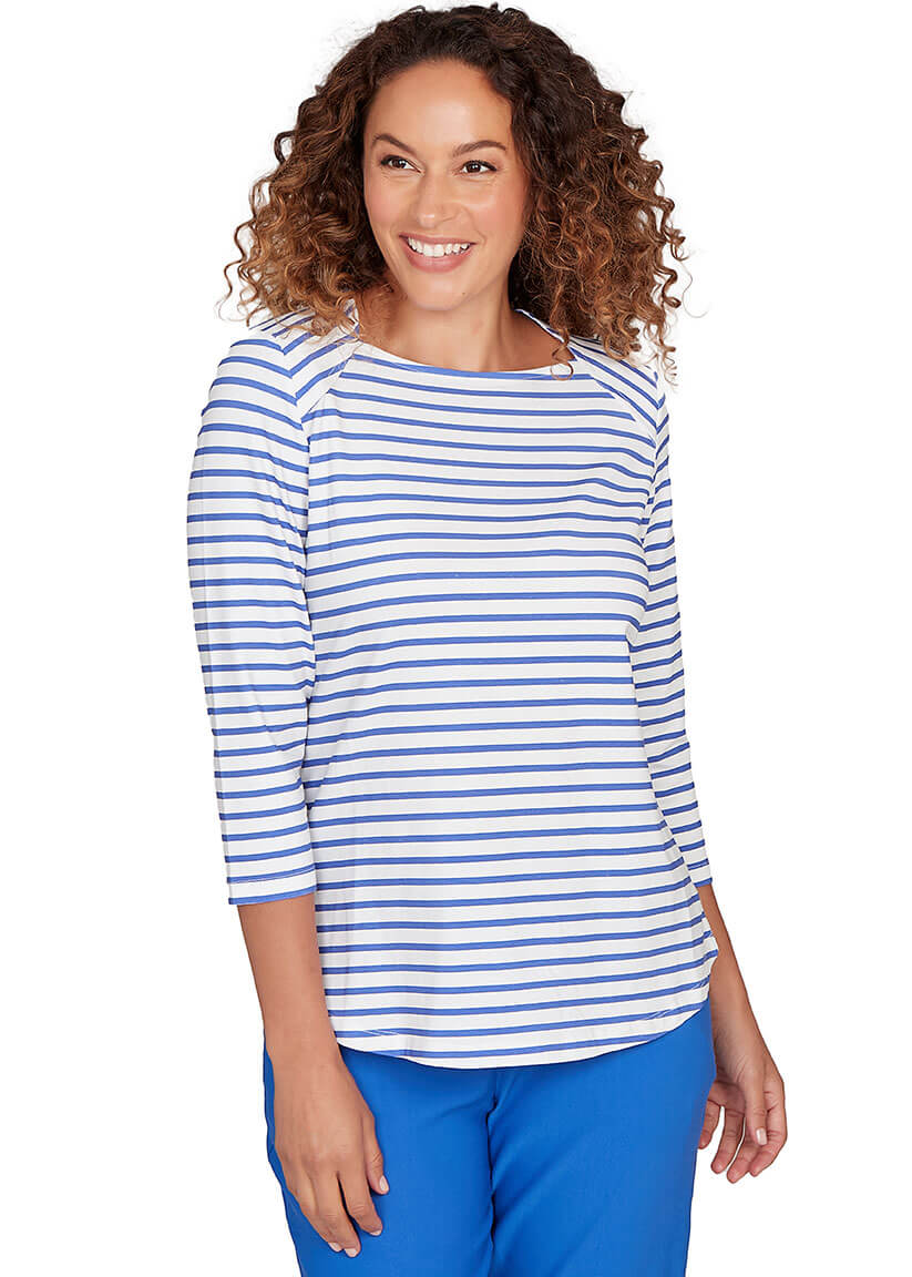 Woman wearing a blue and white striped shirt with blue pants on a white background