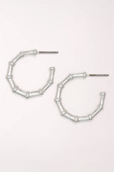 Pair of Periwinkle Silver Bamboo Hoop Earrings: brushed silver-tone open hoops shaped like segmented bamboo, on posts.