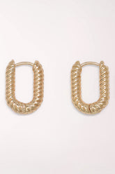 Pair of Periwinkle Gold Ribbed Huggie Hoop Earrings: rounded rectangular gold-tone huggie hoops with a diagonal ribbed, rope-like texture.